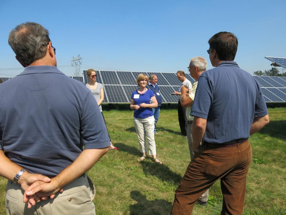 Group of people in a solar field